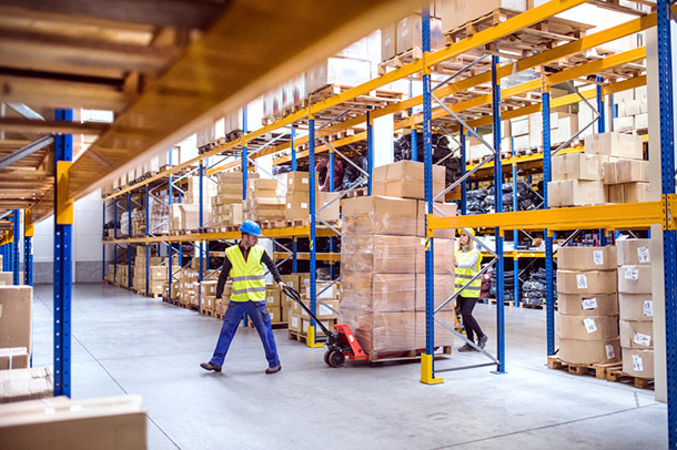 Warehouse workers pulling a pallet truck