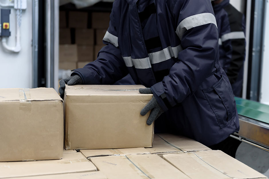 Picking up package boxes in the loading area of cold storage warehouse prepare to transfer storage in the freezing room