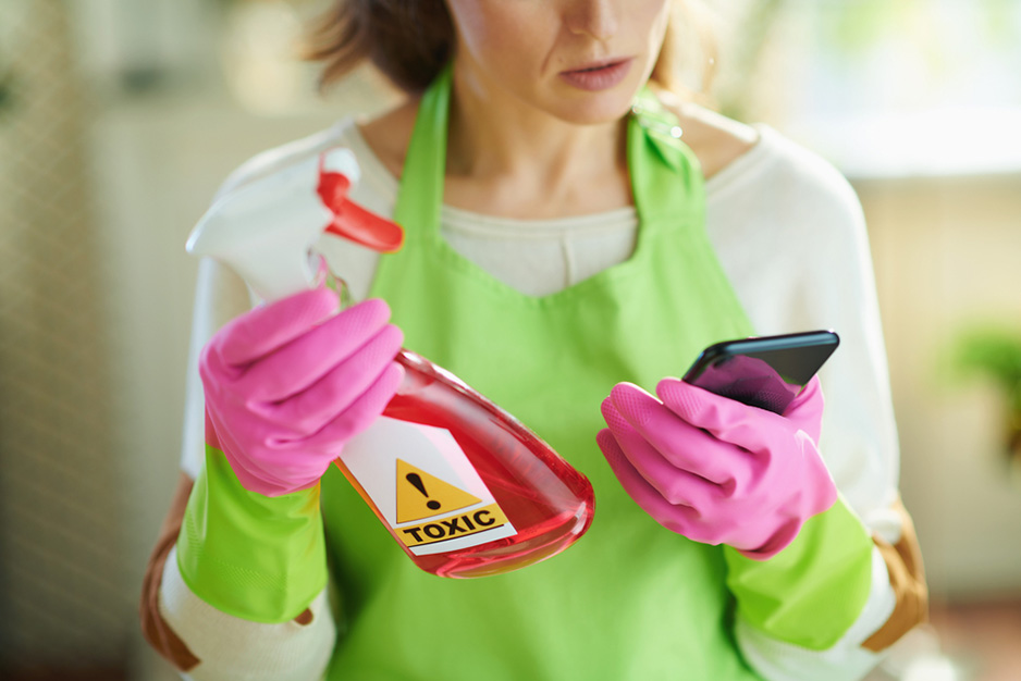 woman in green apron cleaning