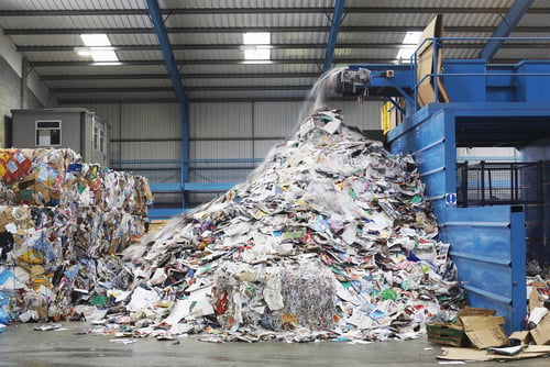 waste falling on pile from conveyer belt