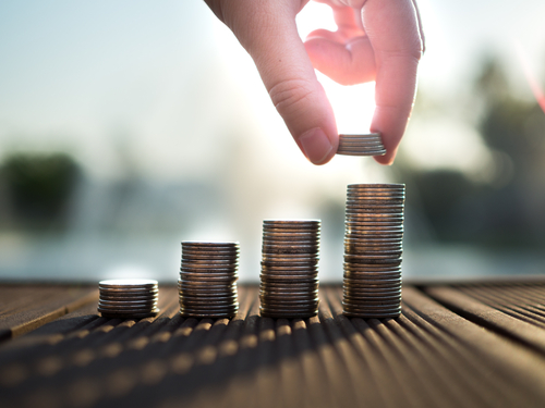 hand placing coins in stacks