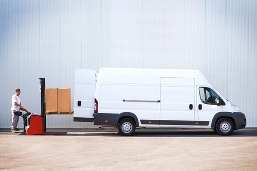 Courier loading a van with parcels