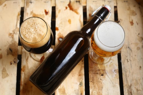 Bottle and full glasses of beer