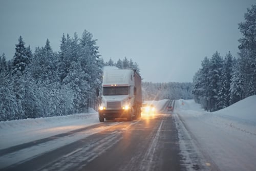 truck rides on a winter snowy road