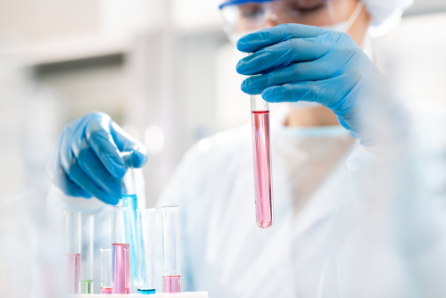 closeup woman working with test tubes