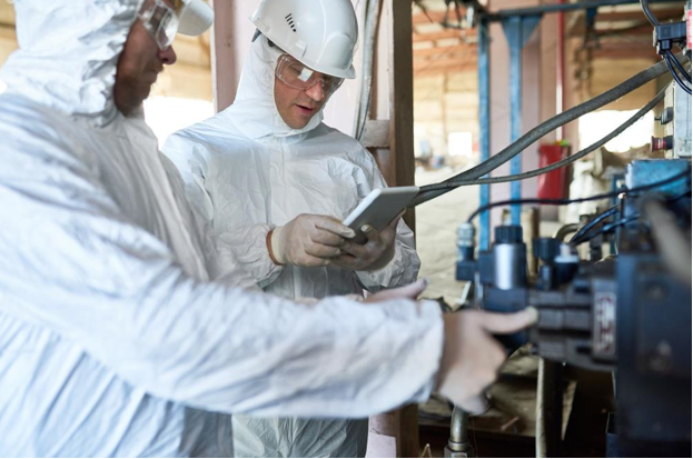men in hazmat suits in factory