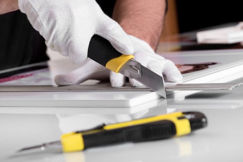 hands cutting panel board