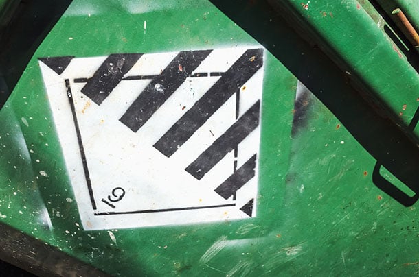 Warning sign on green cargo container