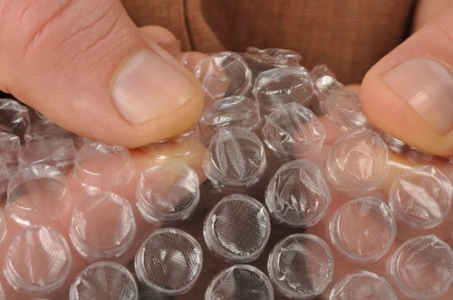 macro hands with bubble wrap
