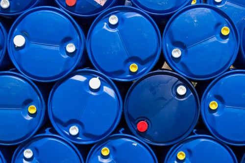 stacked blue plastic drum barrels