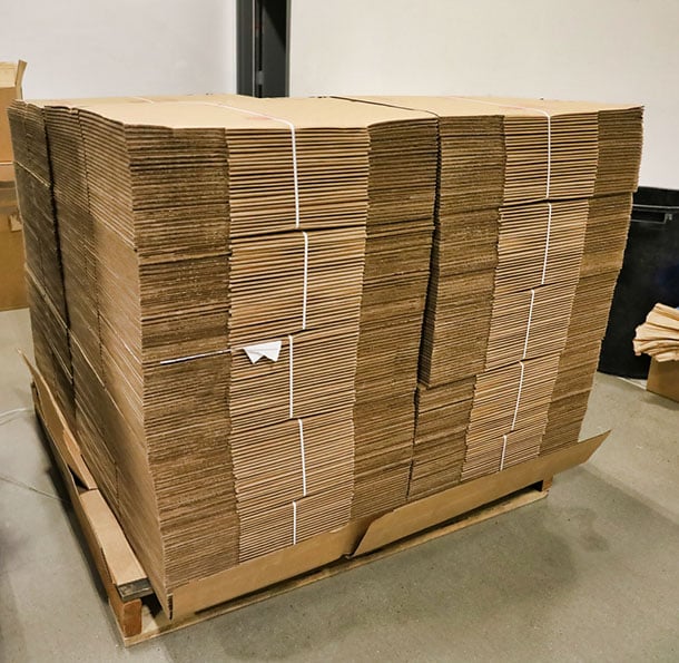 flattened cardboard boxes stacked