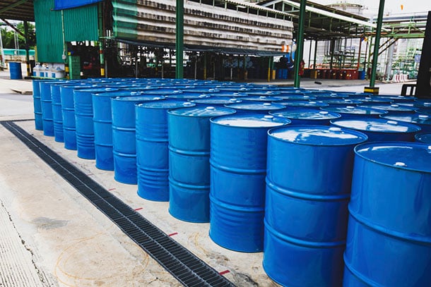 a large group of blue oil barrels