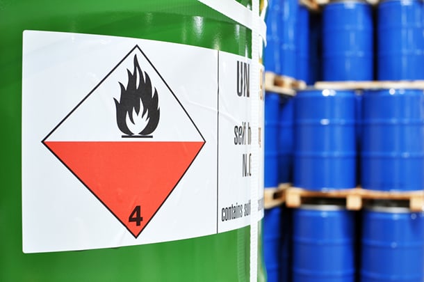 a close up of a chemical drum with a flammable label