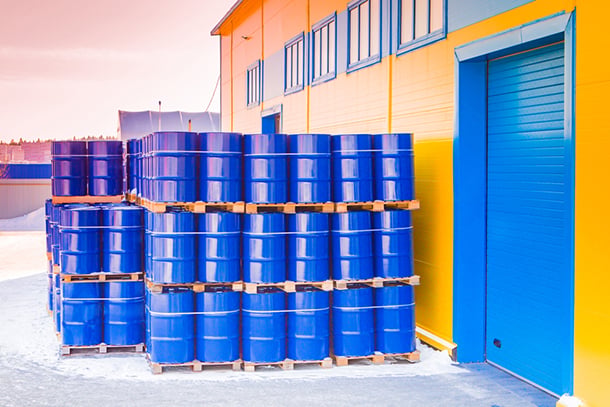 a group of blue containers stacked on pallets