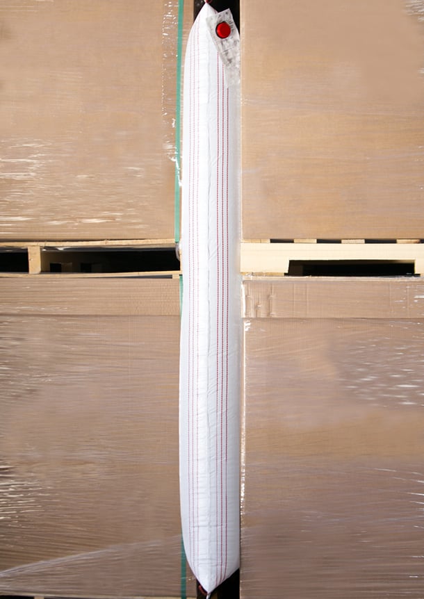 a high strength inflatable airbag between two stacks of pallets