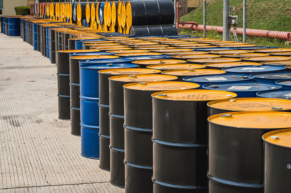 Used 55 gallon chemical drums in a storage yard awaiting recycling