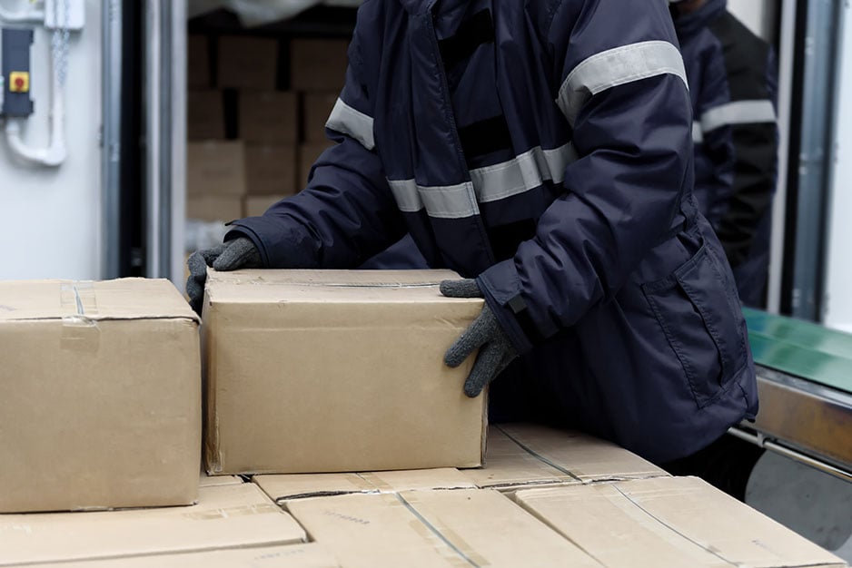 Picking up package boxes in the loading area of cold storage warehouse prepare to transfer storage in the freezing room